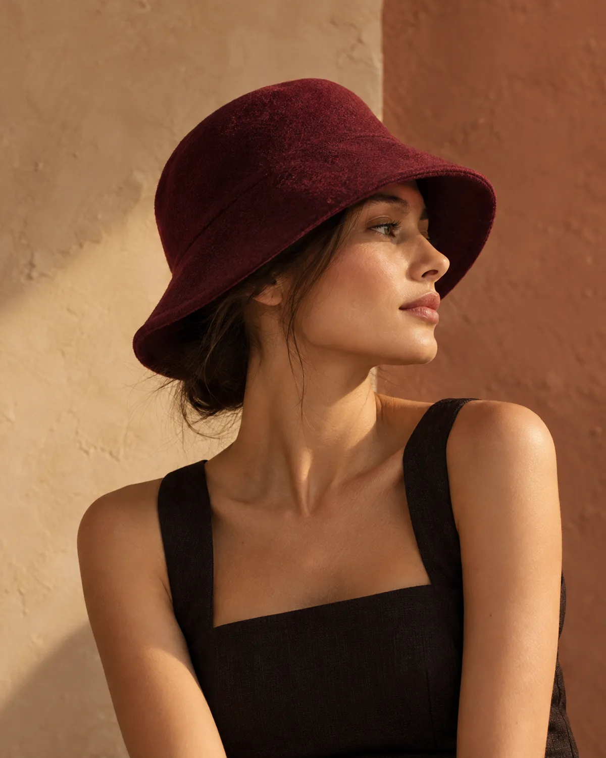 Burgundy felt bucket hat in evening light